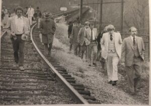 People walking to the trestle and the lake house